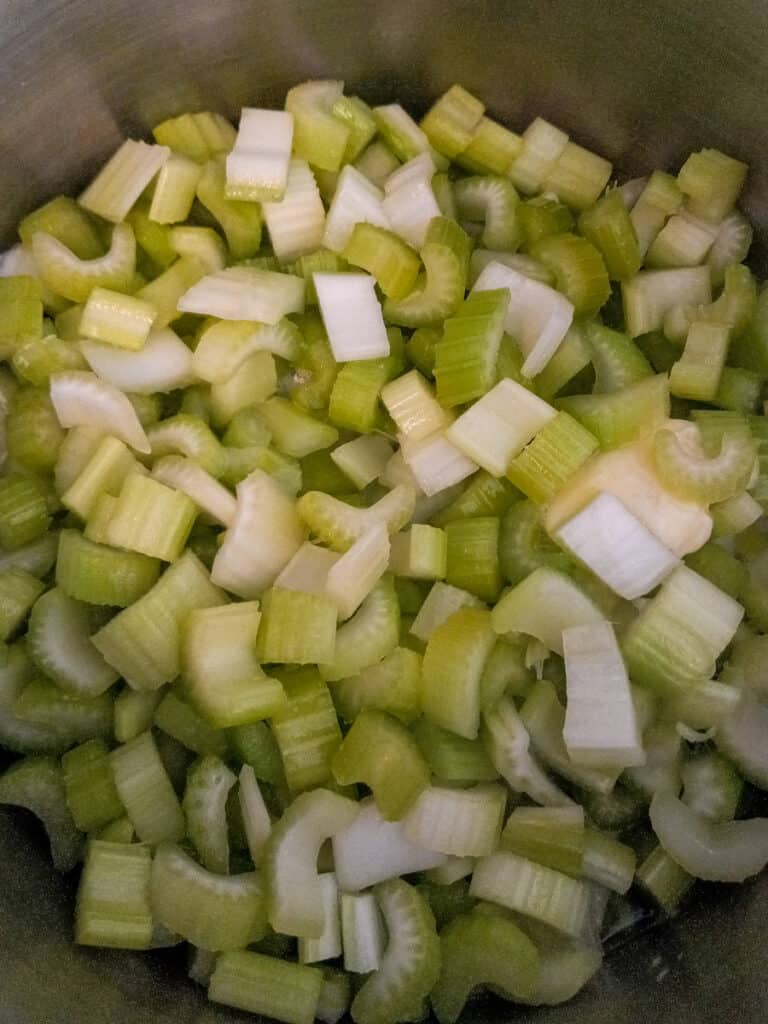 cut celery in a large cooking pot.