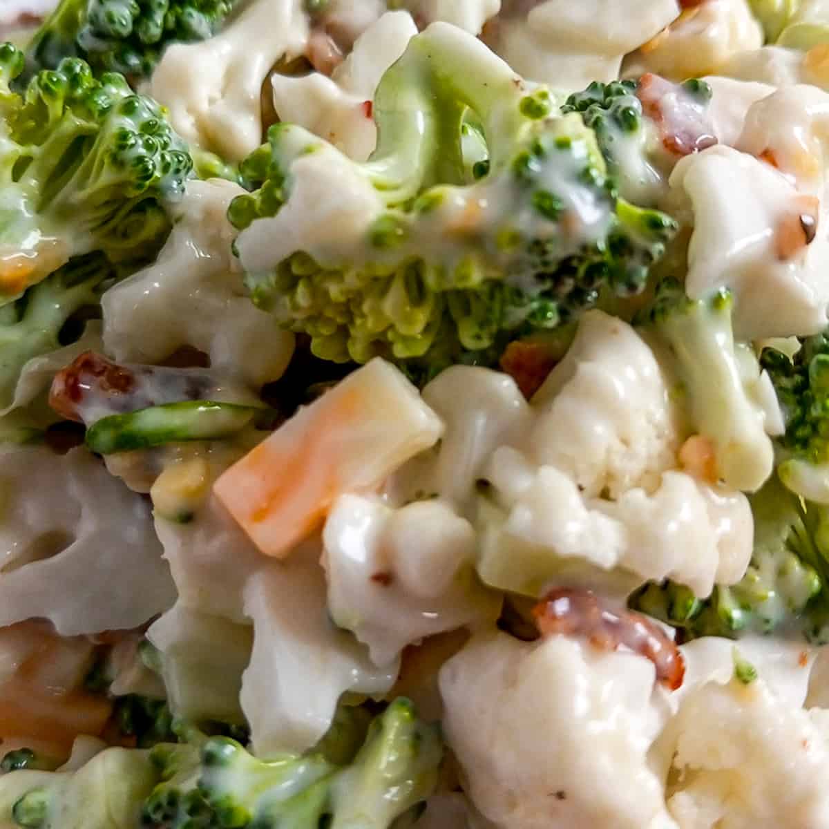 closeup of Amish broccoli salad with cauliflower,cheese, and bacon.