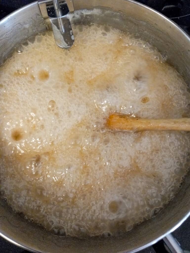 the caramel mixture is getting darker as it's cooking.