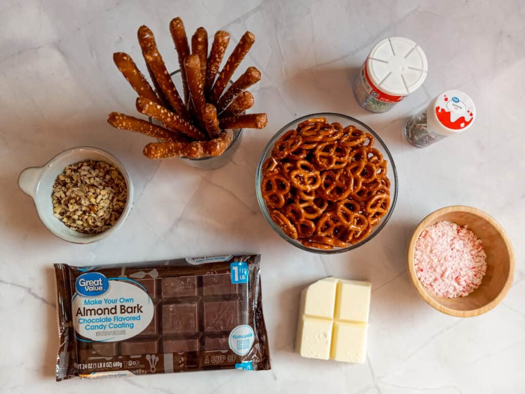 Ingredients: pretzel rods, mini pretzel twists, almond bark, crushed candy canes, sprinkles, and chopped nuts.