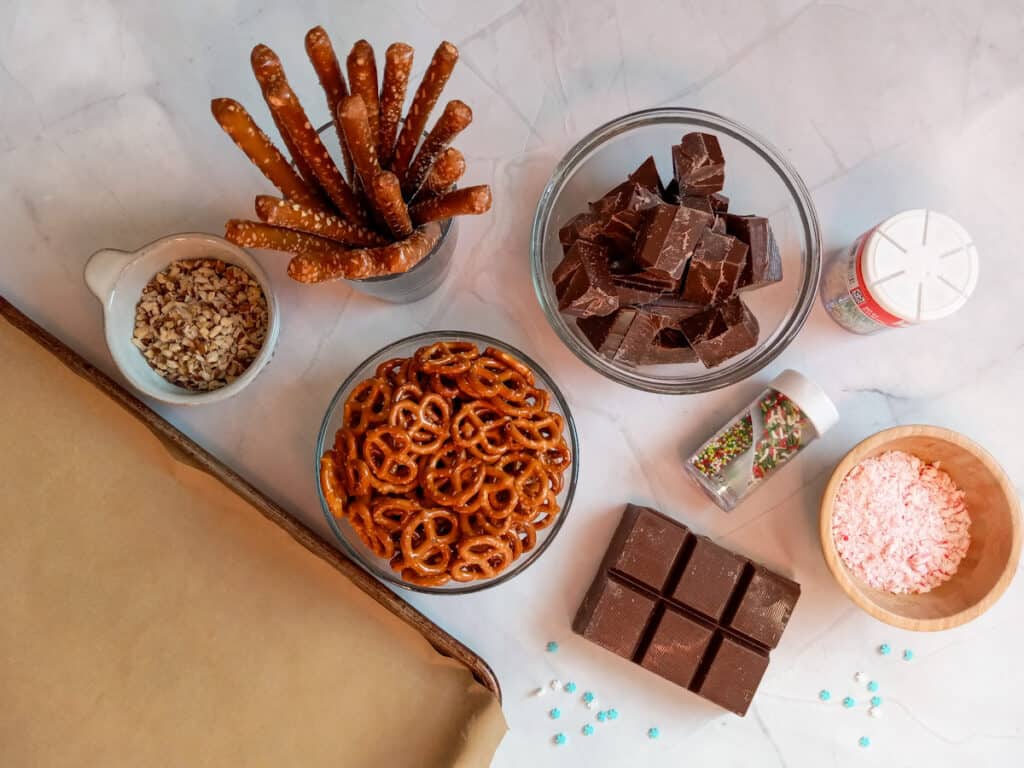 all the ingredients to get started dipping pretzels: almond bark, pretzels, and toppings.