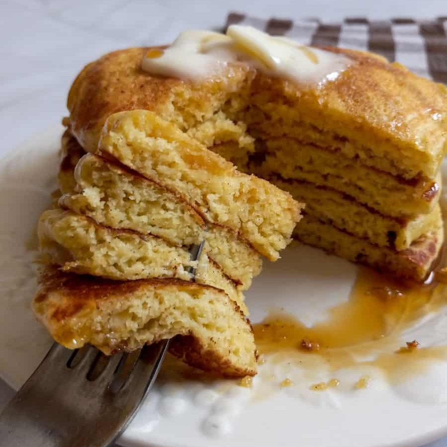 a stack of fluffy Amish pancakes on a plate ready to serve for breakfast.
