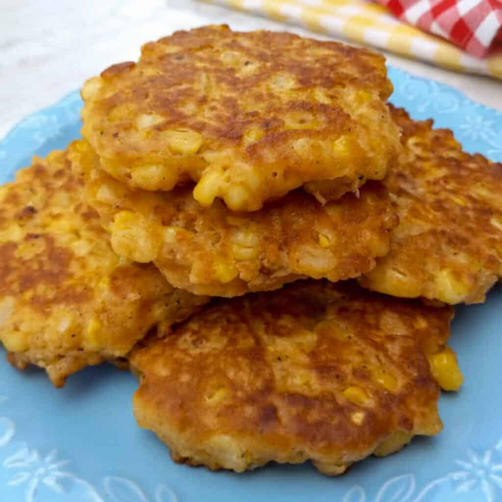 PA Dutch corn fritters stacked on a plate.