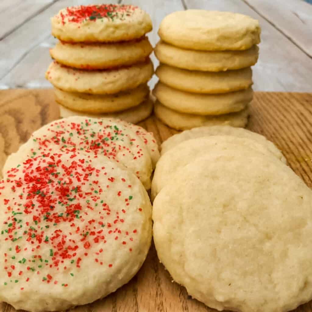 Amish sugar cookies stacked on a board.