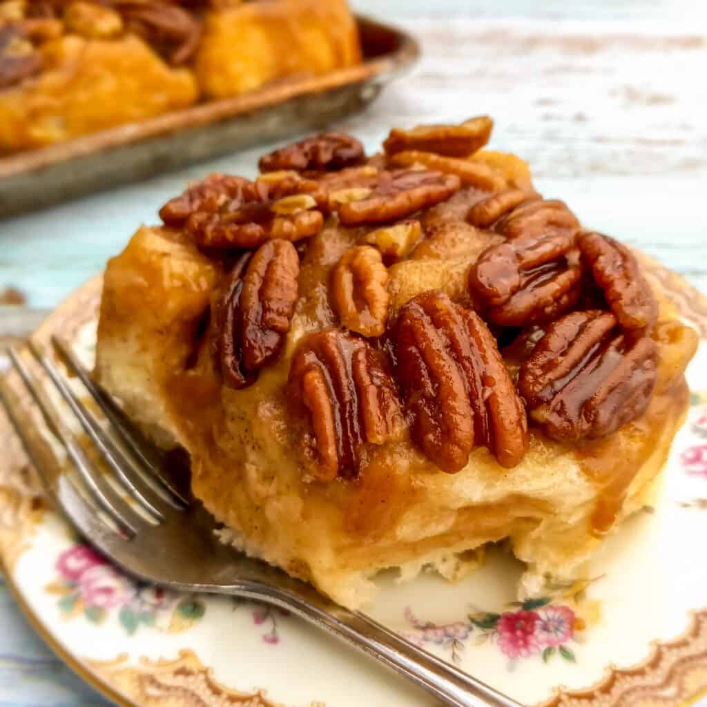 pecan-topped gooey Amish sticky bun on a plate ready to eat.
