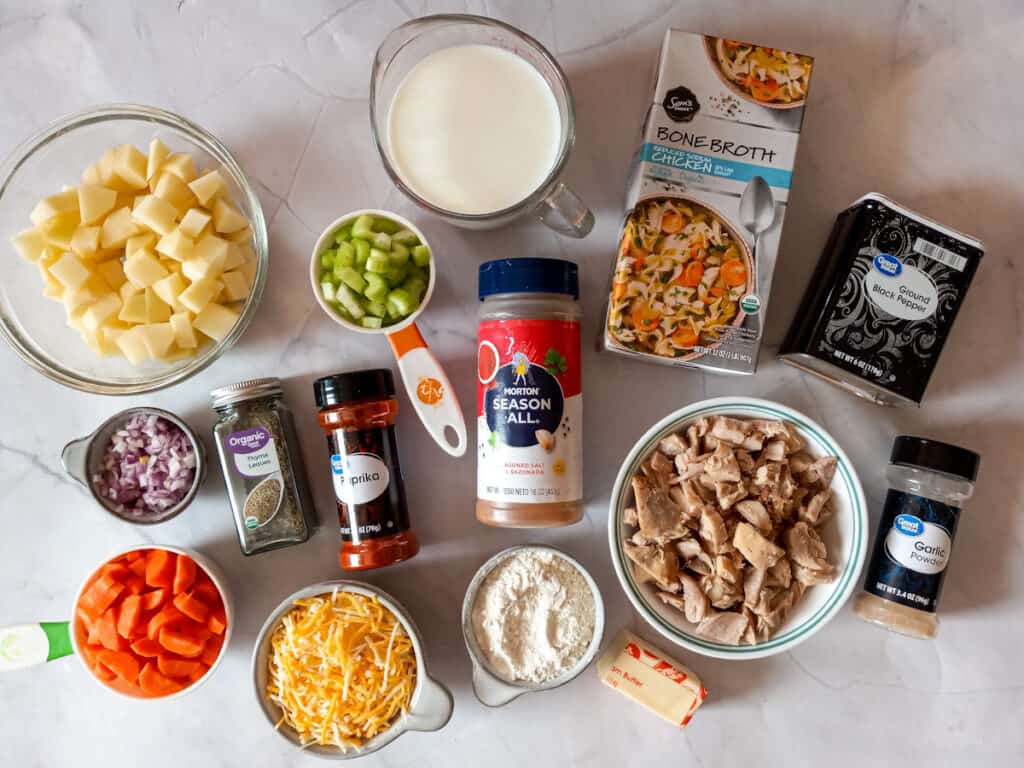 Prepared ingredients: chopped veggies, potatoes, chicken, broth, butter, flour, milk, and seasonings.