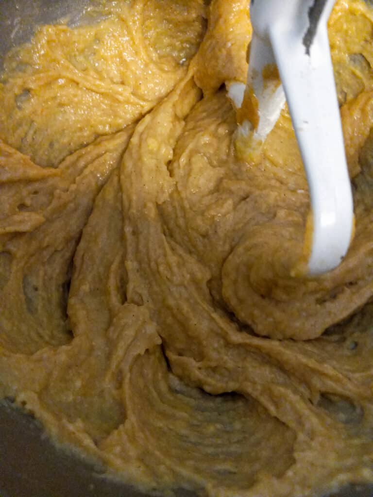 mixing friendship bread batter in a large bowl with paddle attachment.