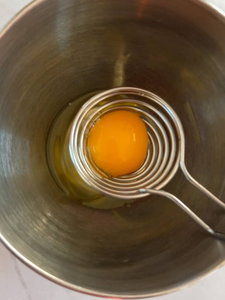 separating the eggs into a bowl.