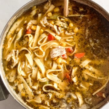 a large pot of chicken corn noodle soup.