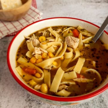 a bowl of yummy looking Amish noodle soup with corn and chicken.