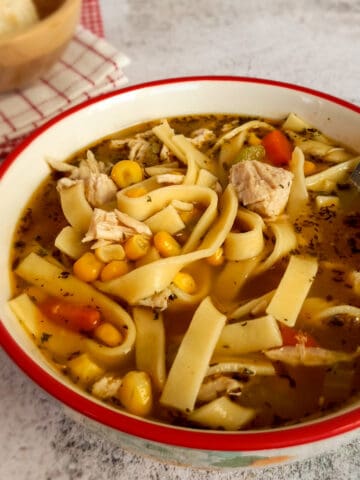 a bowl of yummy looking Amish noodle soup with corn and chicken.