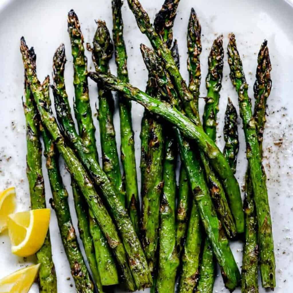 grilled asparagus on a plate to serve as a side with burgers.