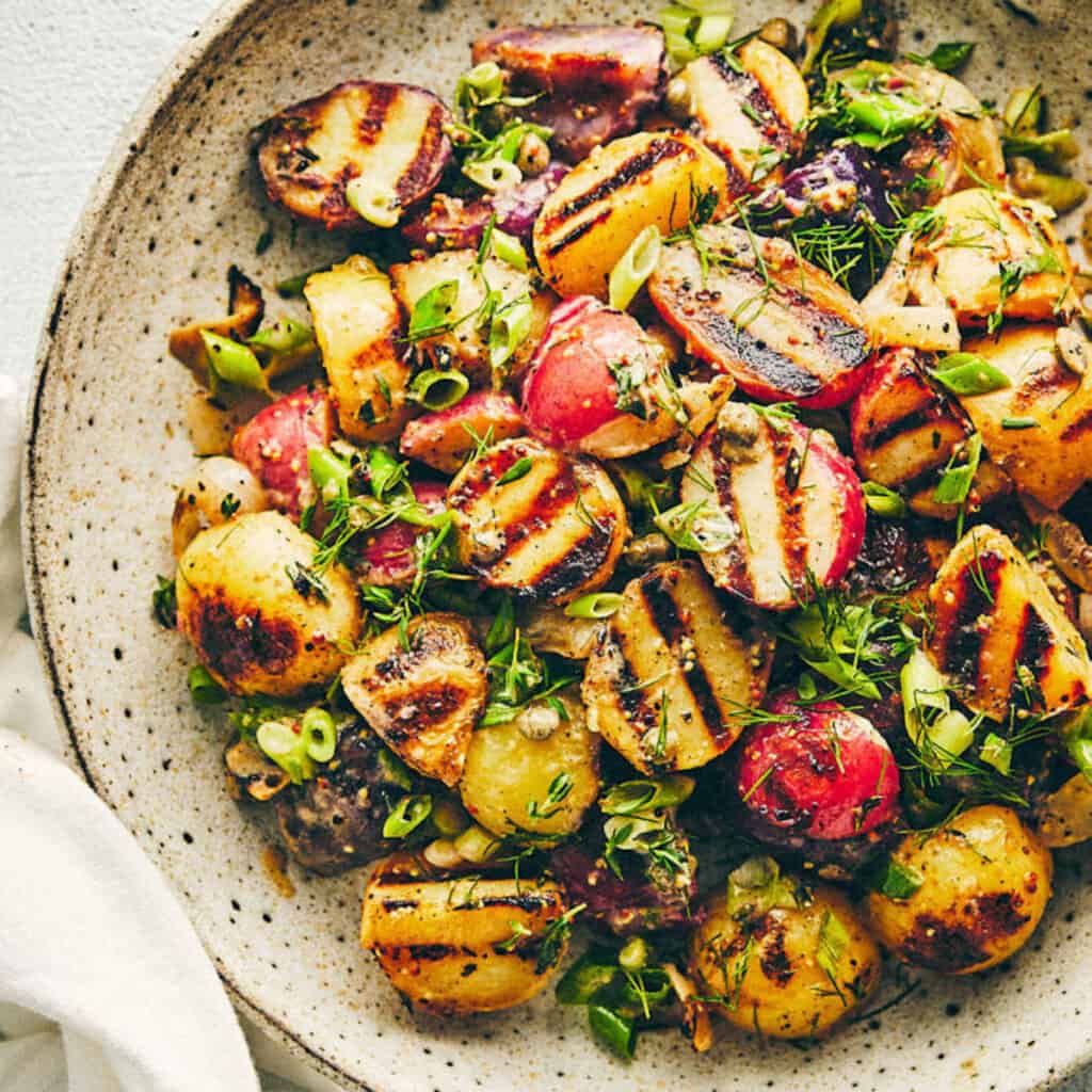 a plate of yummy looking grilled potato salad.