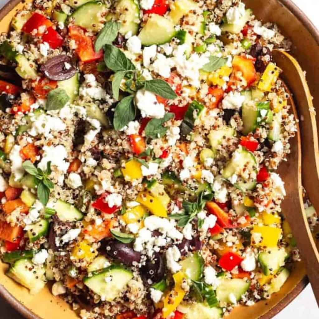 a bowl of mediterranean quinoa salad.
