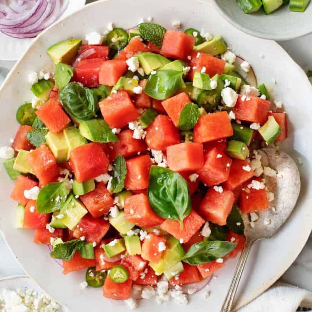 a bowl of watermelon salad to serve as a side for burgers.
