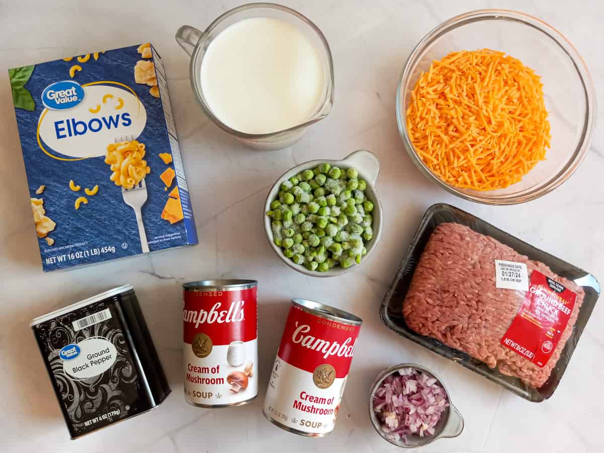Ingredients: elbow macaroni, ground beef, peas, cream of mushroom soup, cheese, milk, onions, and black pepper.
