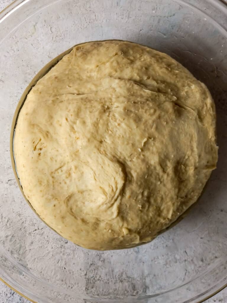 oat bread dough in a large bowl ready to rise.