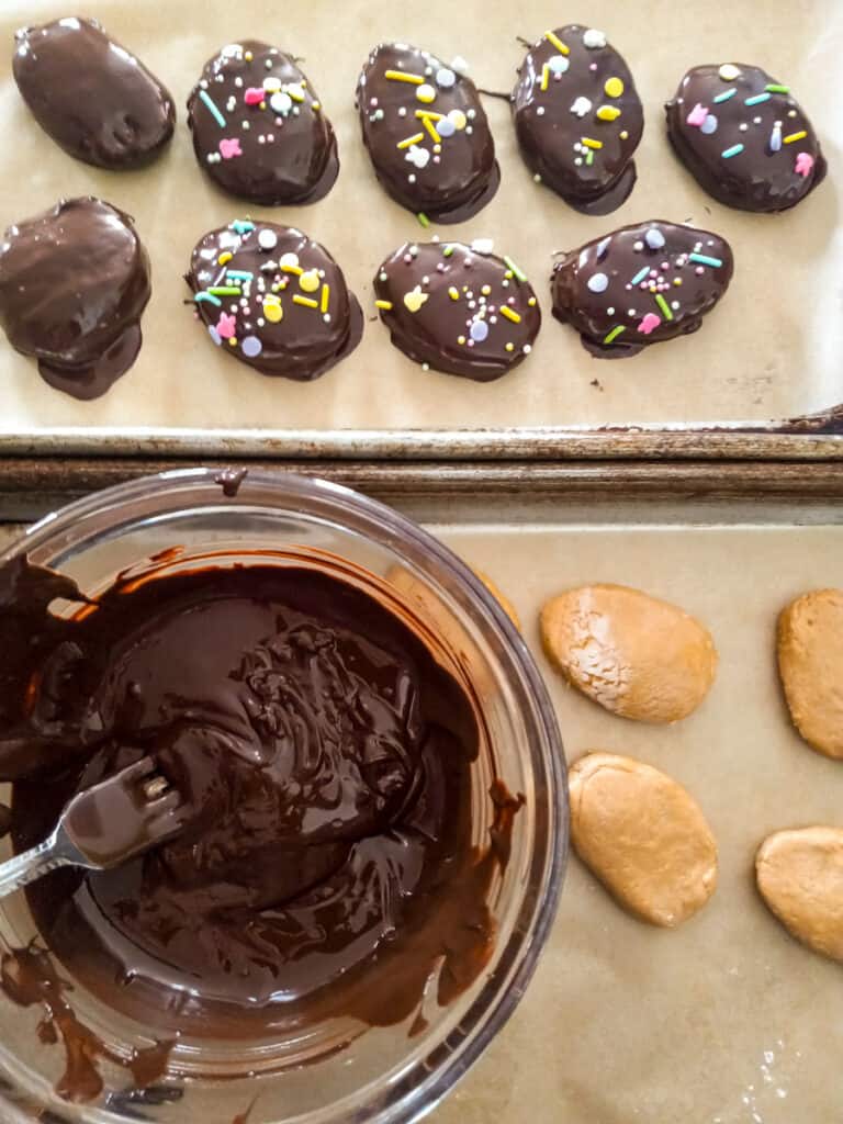 dipping peanut butter eggs in melted chocolate.