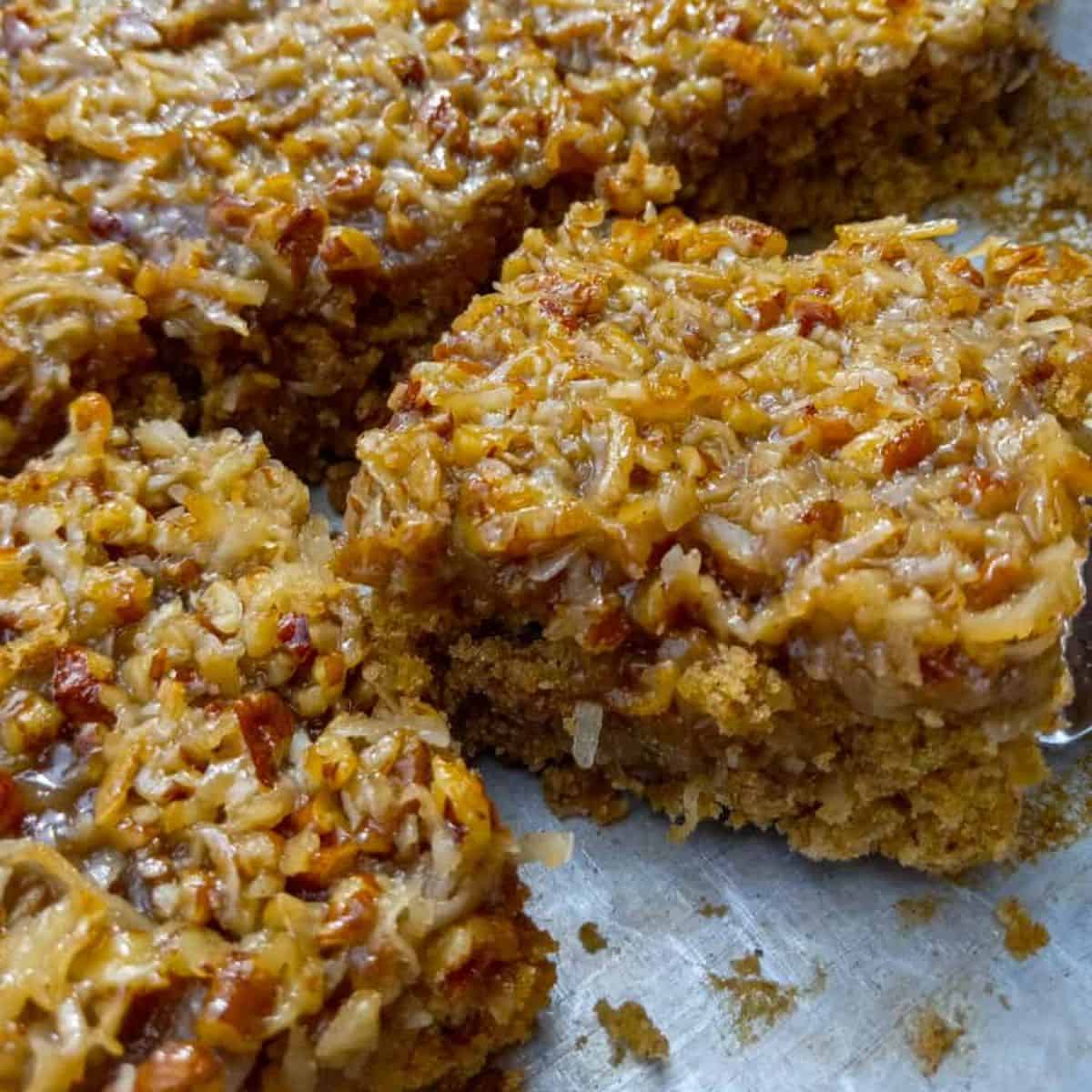 a couple slices of old-fashioned Amish oatmeal cake with broiled coconut frosting in a cake pan.