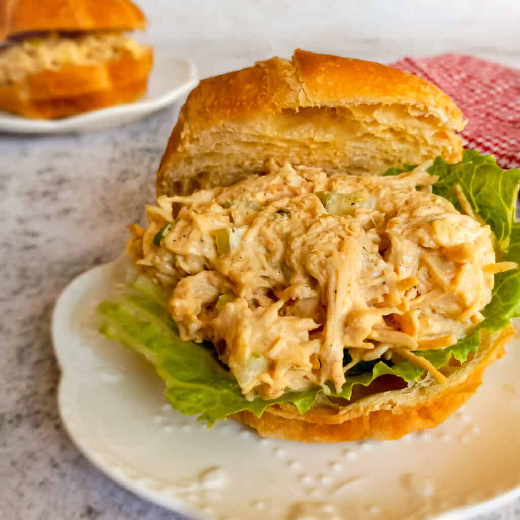 creamy Amish chicken salad and lettuce on a croissant.