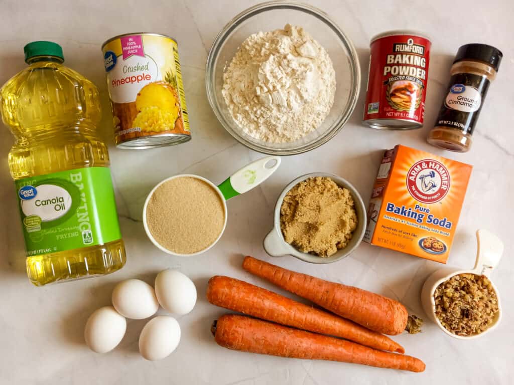Ingredients: carrots, oil, sugar, brown sugar, pineapple, eggs, flour, baking soda, baking powder, cinnamon, and chopped nuts.