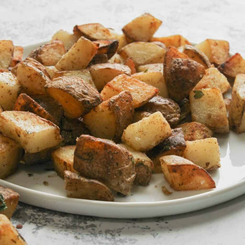 a plate full of crispy fried potatoes.