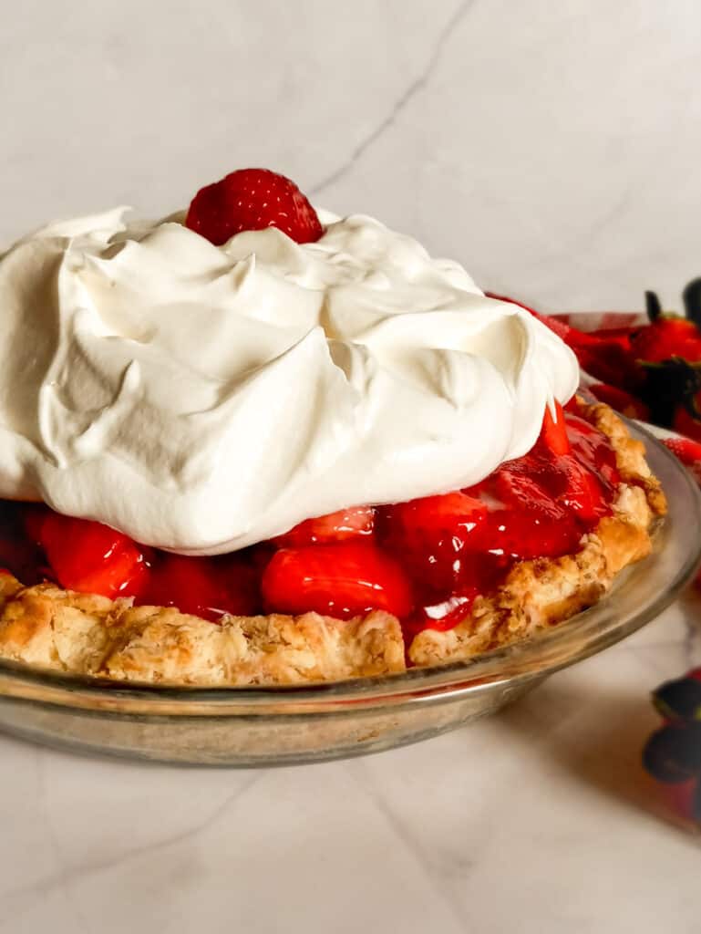 9" Amish strawberry pie topped with Cool Whip.