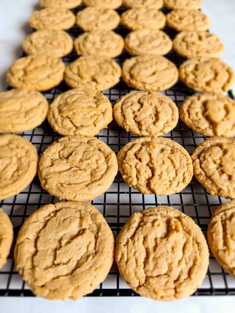 peanut butter cookies cooling on a wire rack.