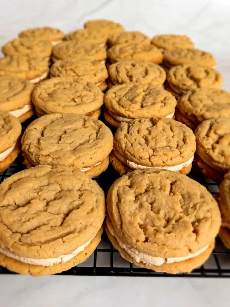 filled peanut butter whoopie pies on a wire rack.