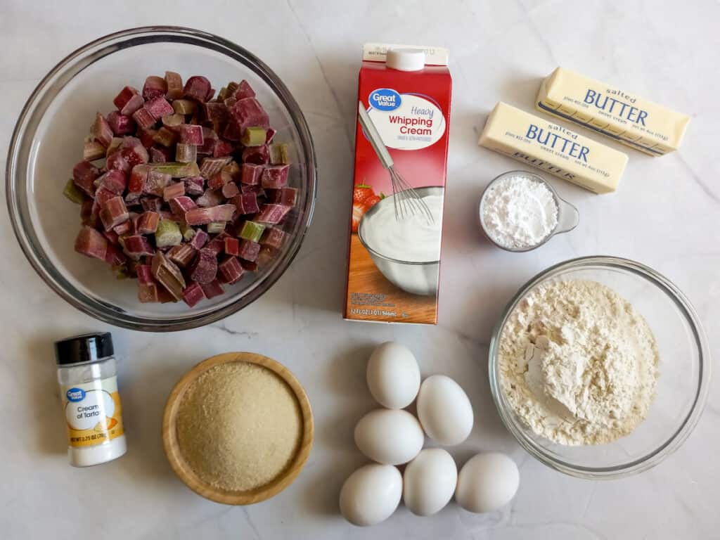 Ingredients: rhubarb, heavy cream, butter, sugar, powdered sugar, eggs, flour, and cream of tartar.