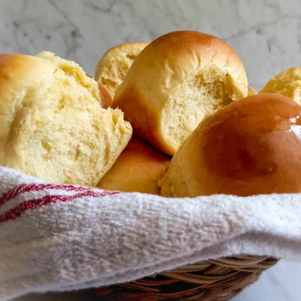a basket full of homemade dinner rolls.