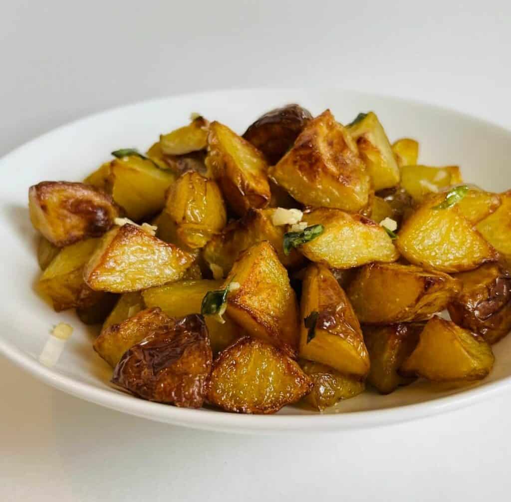 a bowl of garlicky roasted potatoes.