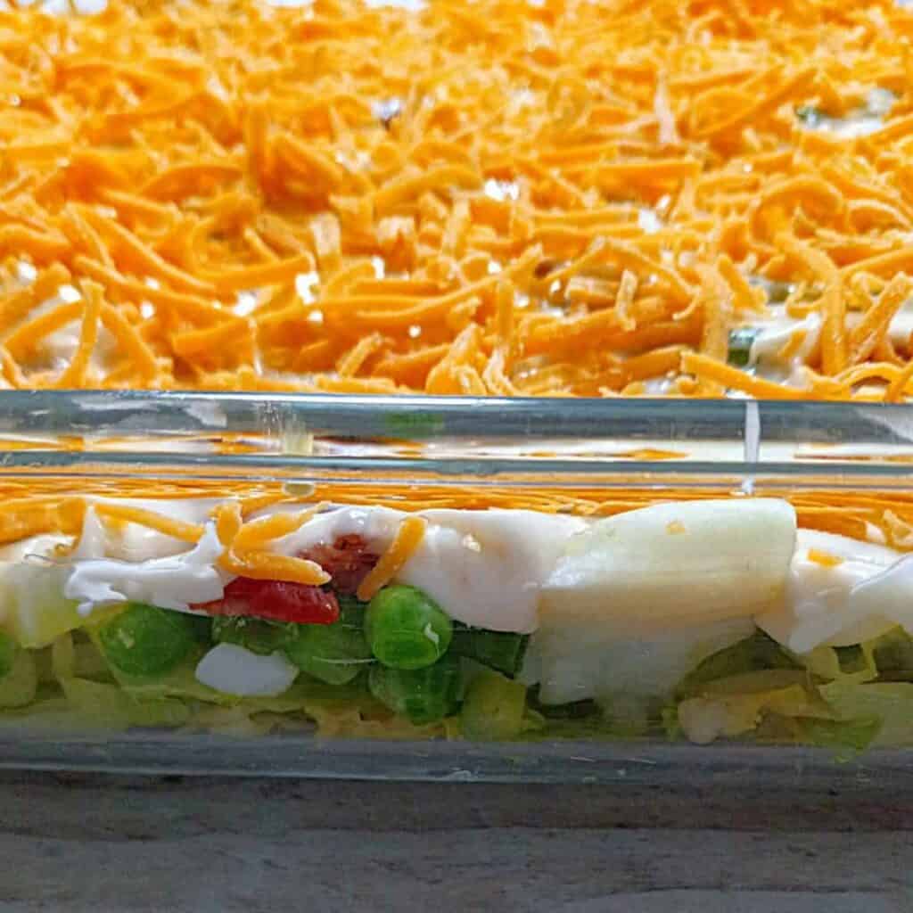 a pan with layered lettuce salad.