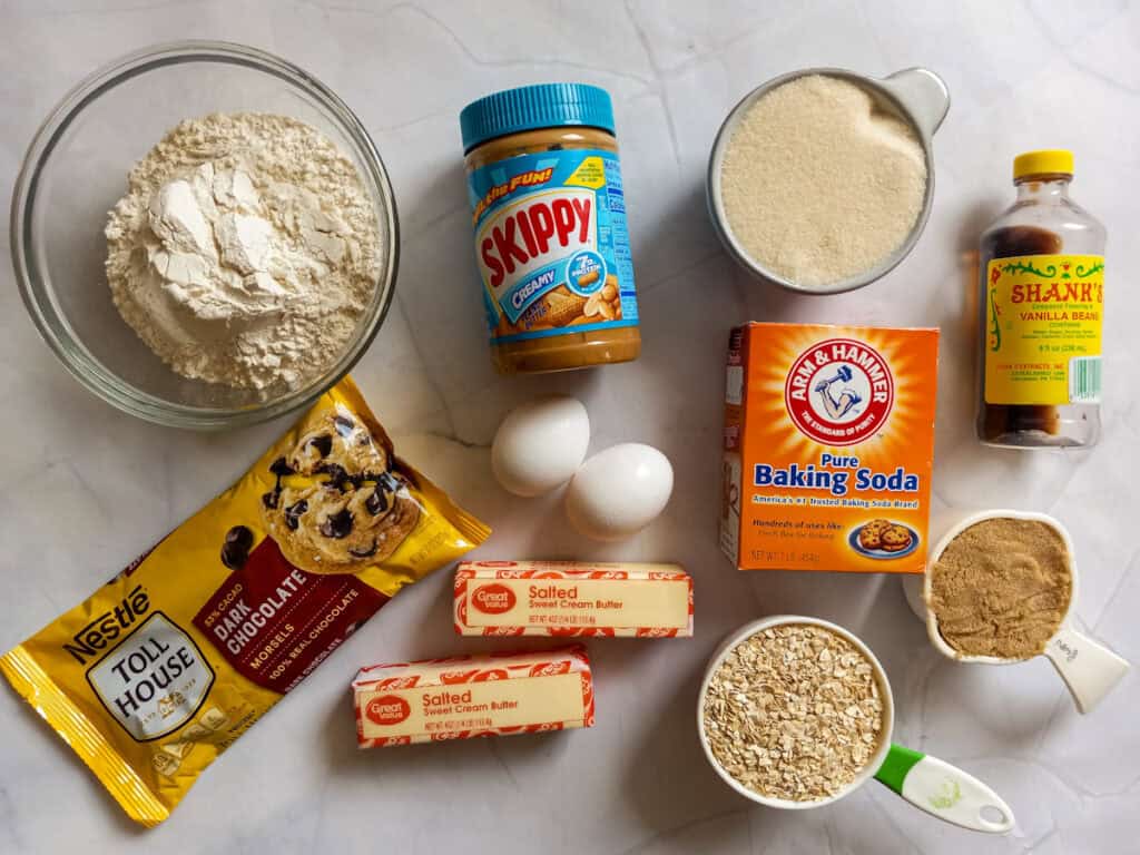 Ingredients: flour, peanut butter, sugar, brown sugar, oats, vanilla, butter, baking soda, eggs, and chocolate chips.
