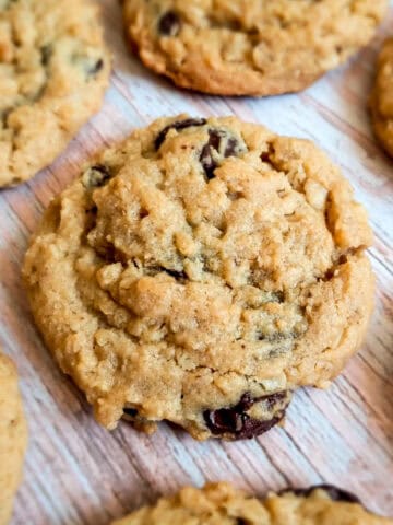 Outrageous chocolate chip cookies on a wood grain looking background.