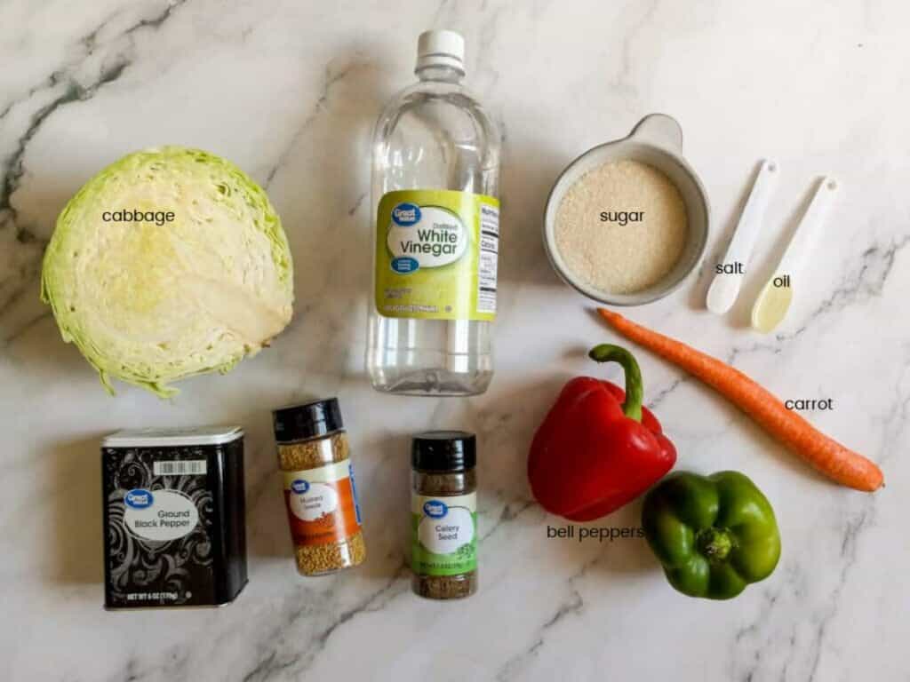 Ingredients: cabbage, green pepper, red pepper, carrot, vinegar, sugar, salt, oil, black pepper, celery seed, and mustard seed.