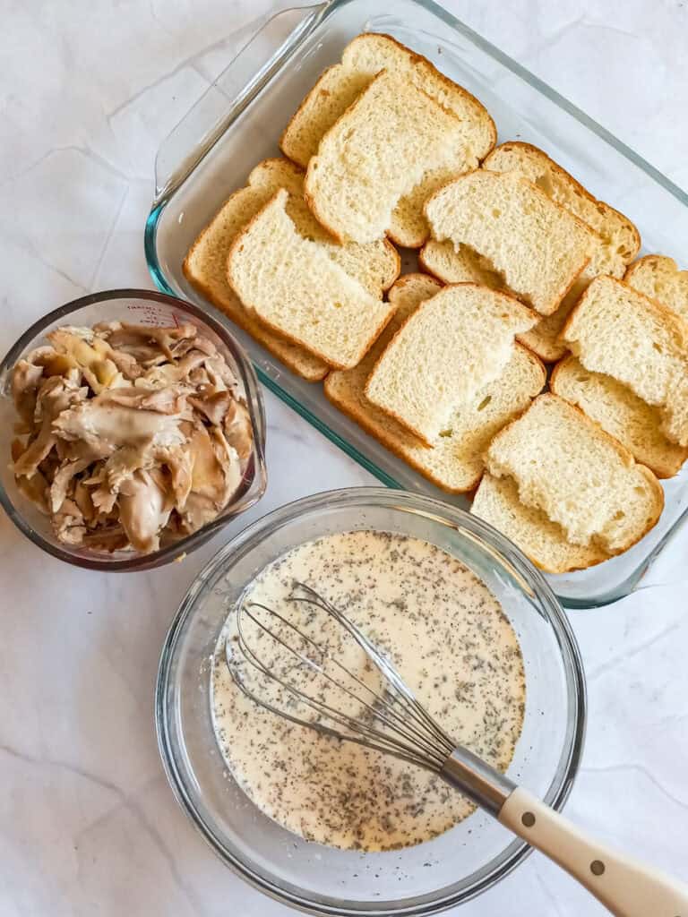 bread layered into a 9x13" dish, chicken in a bowl, and the creamy mixture in another bowl.