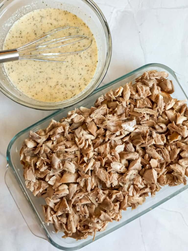 bread in the bottom of the dish, topped with cooked chicken, and the sauce in a another bowl.