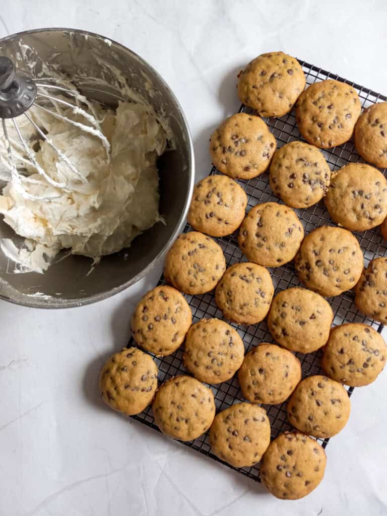 cookies on a wire rack and a bowl of whoopie filling.