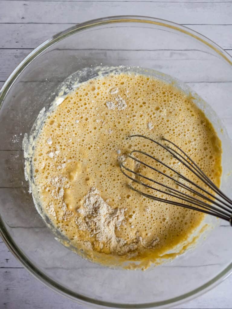 mixing cornbread batter in a large bowl.