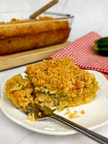 getting ready to enjoy a bite of Amish zucchini casserole from a serving on a plate.