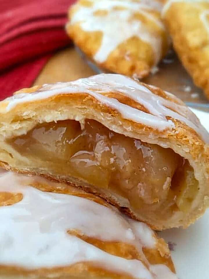 an apple fry pie cut in half to let you see the inside.