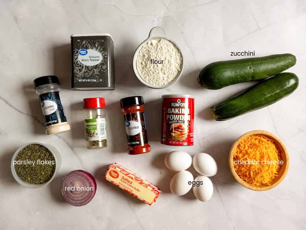 Ingredients: zucchini, cheese, flour, baking powder, butter, eggs, onion, and seasonings.