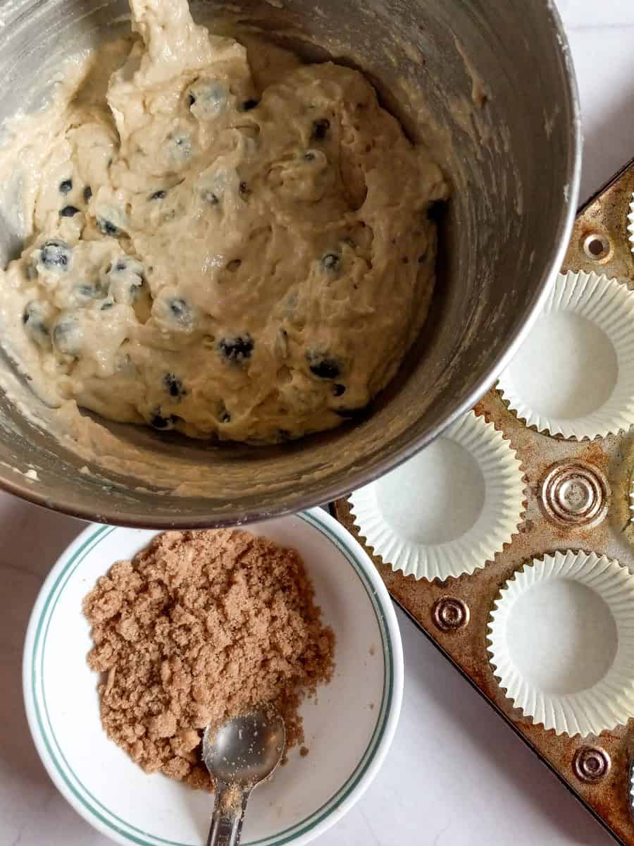 ready to scoop muffin batter into the tin and top it with streusel.