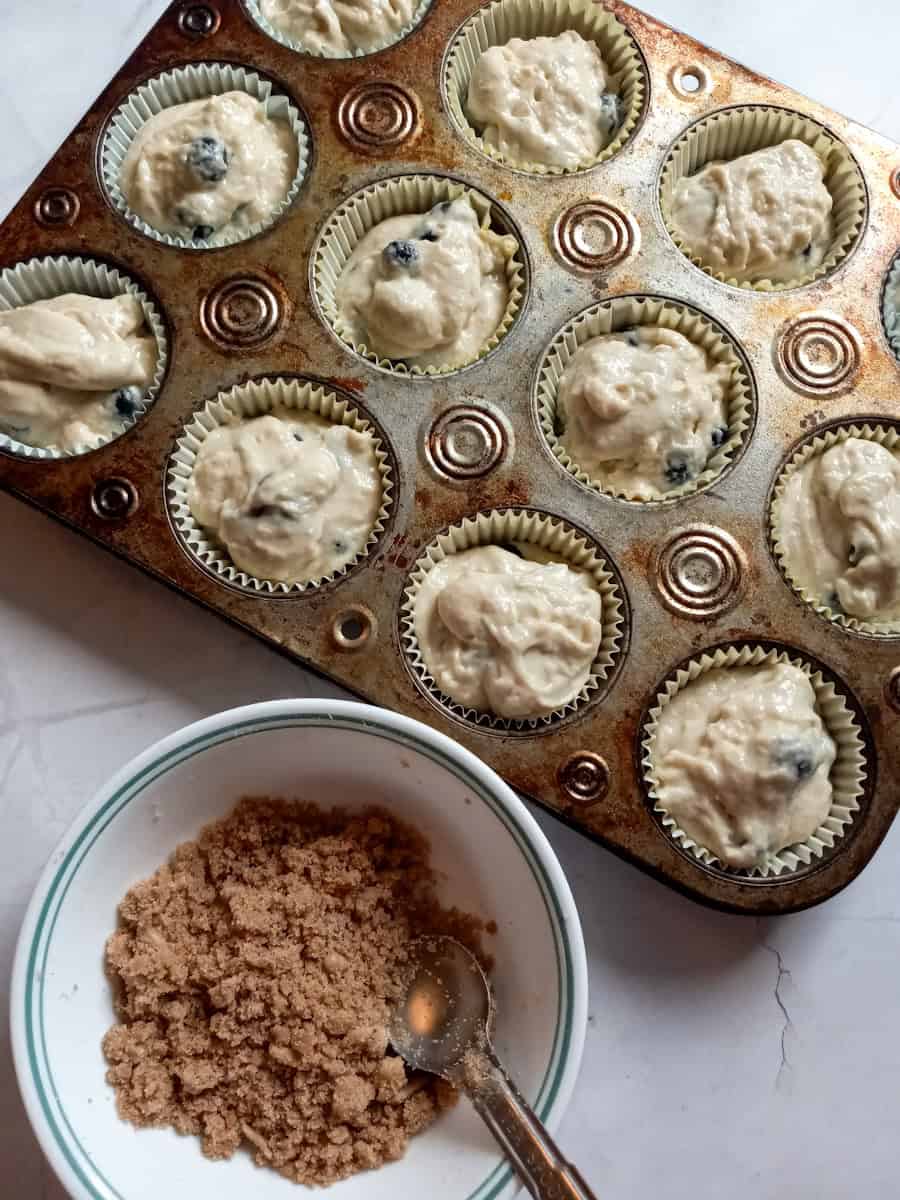 filled muffin tins, and ready to spread streusel over the top.