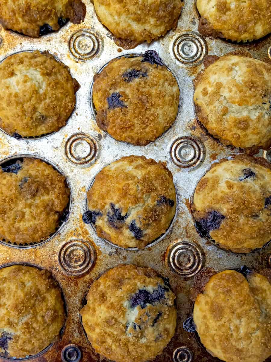 beautifully baked blueberry buttermilk muffins in a tin.