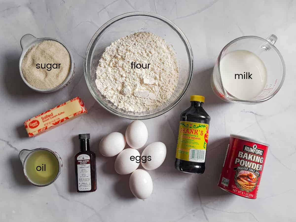 Ingredients: eggs, vanilla, almond extract, butter, oil, sugar, flour, milk, and baking powder.