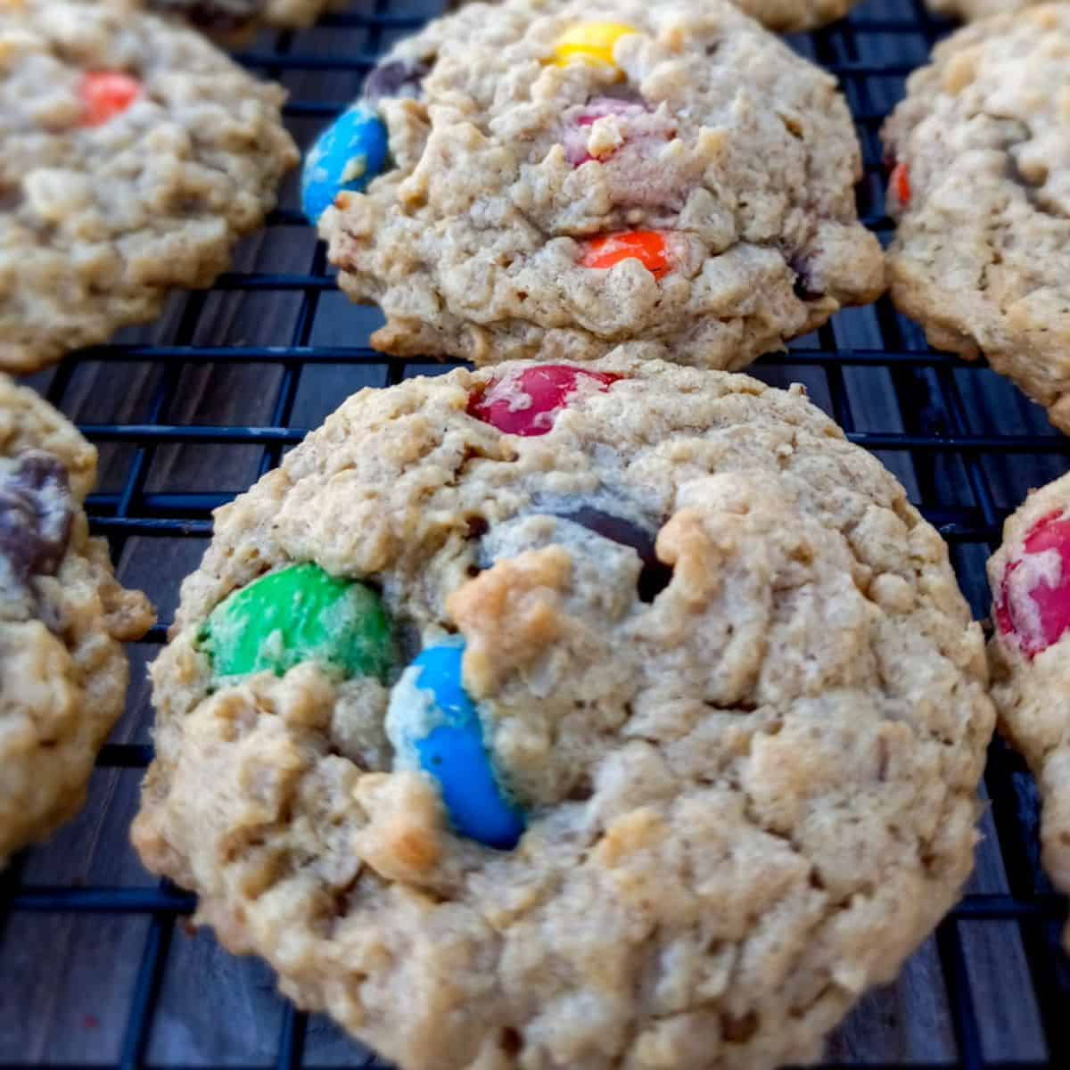 M&M monster cookies without flour on a wire rack.