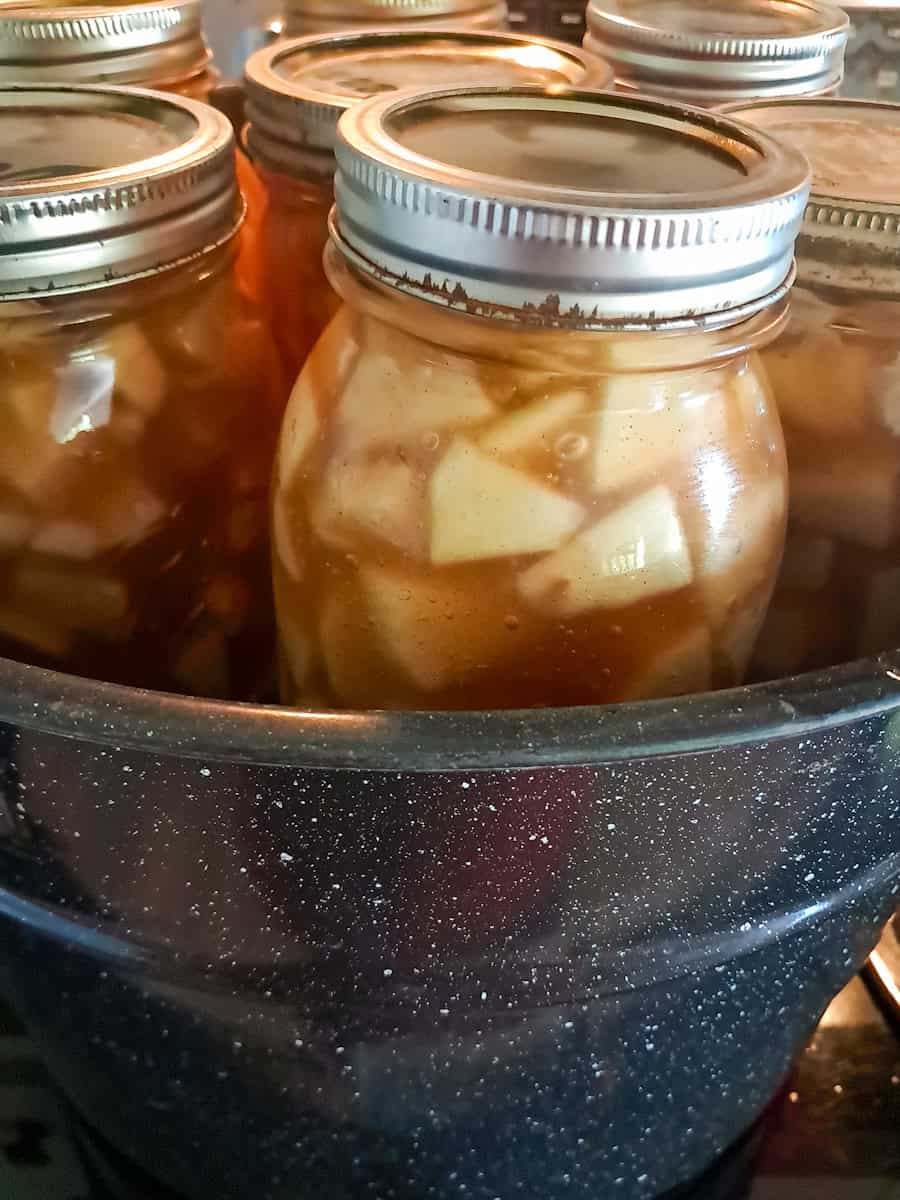 a canner filled with jars of pie filling.