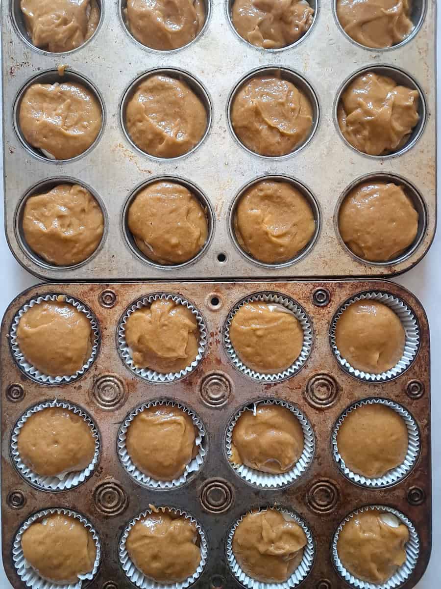 2 muffin tins with batter, ready for the topping.
